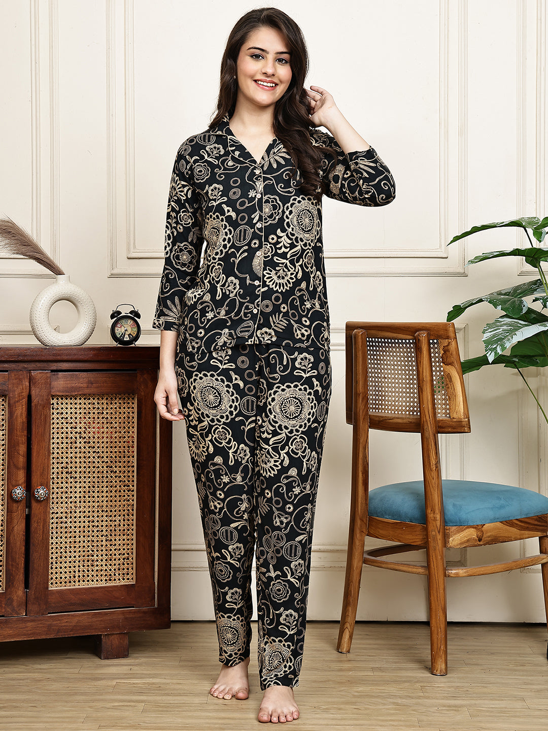 Woman wearing a black ethnic print night suit,