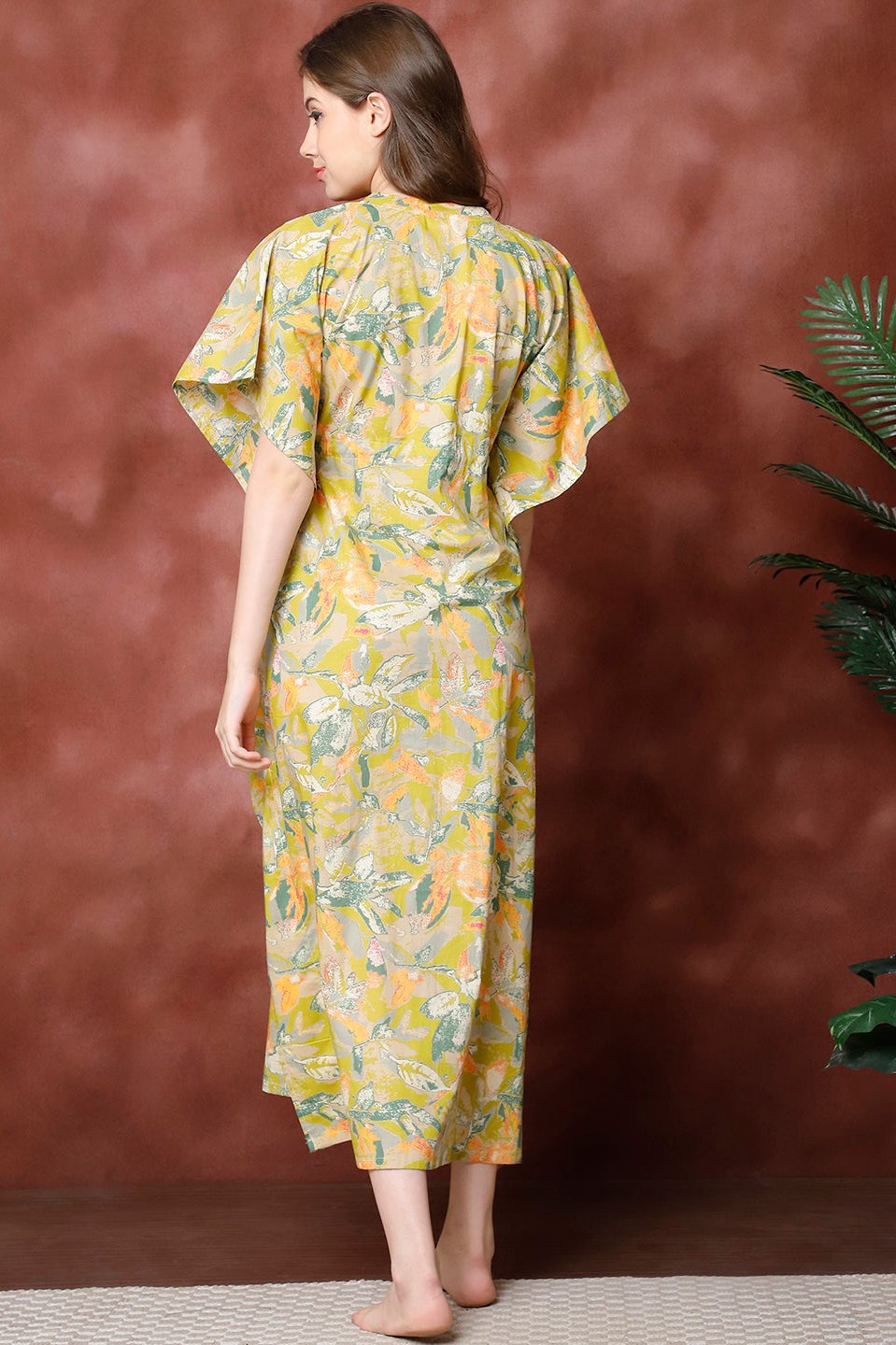 Back view of model in green floral printed Kaftan Dress