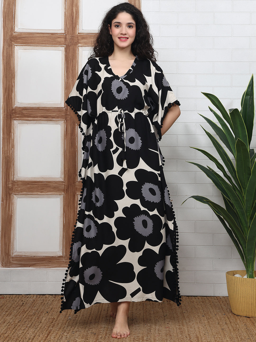 Woman wearing black floral Kaftan Dress