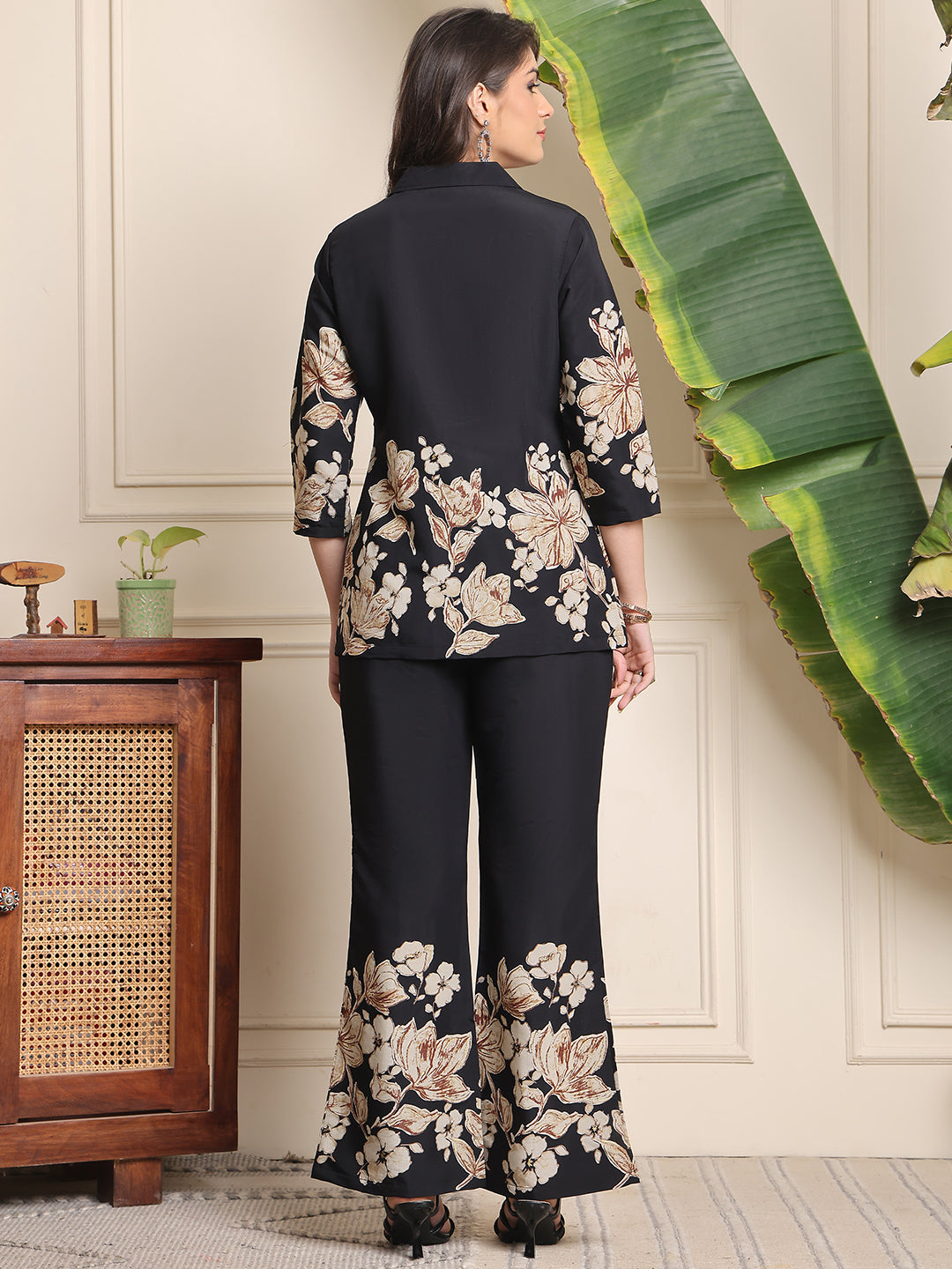 Back view of model styling black co-ord outfit