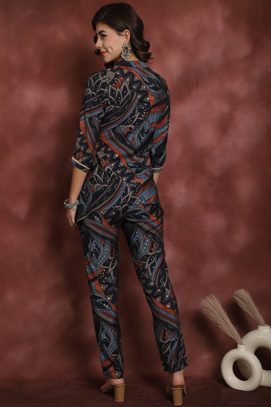 Back view of model styling Navy co-ord outfit with 3/4 sleeves