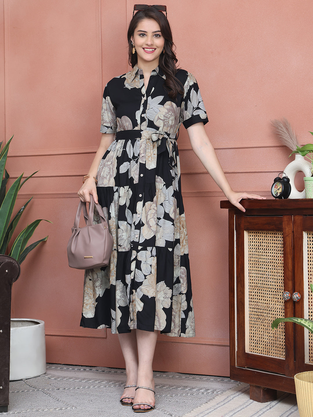 Woman wearing black floral printed dress