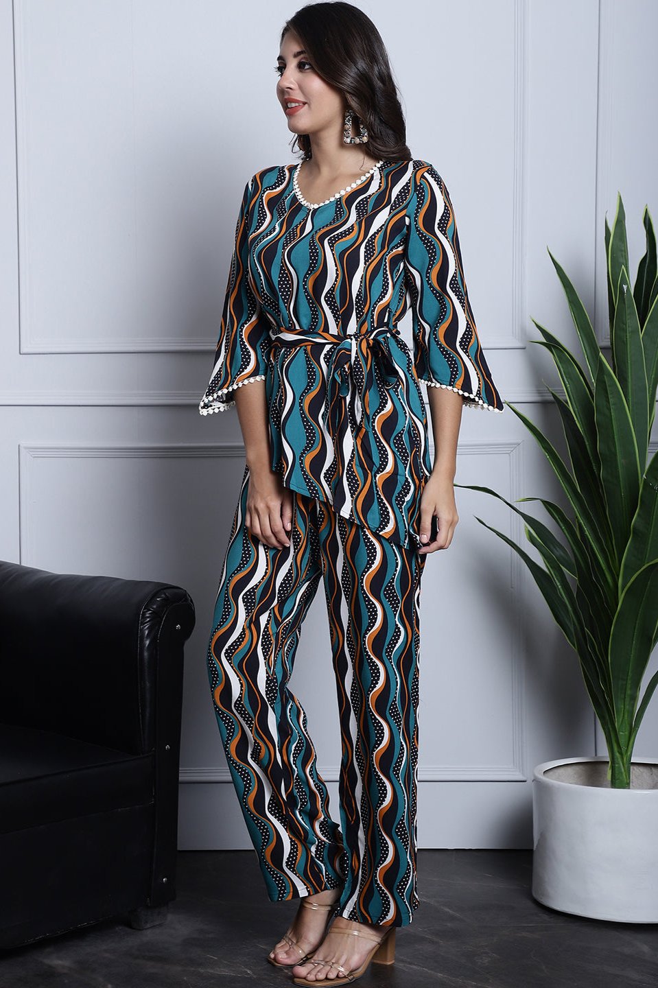 Back view of a model styling the green geometric co-ord outfit.