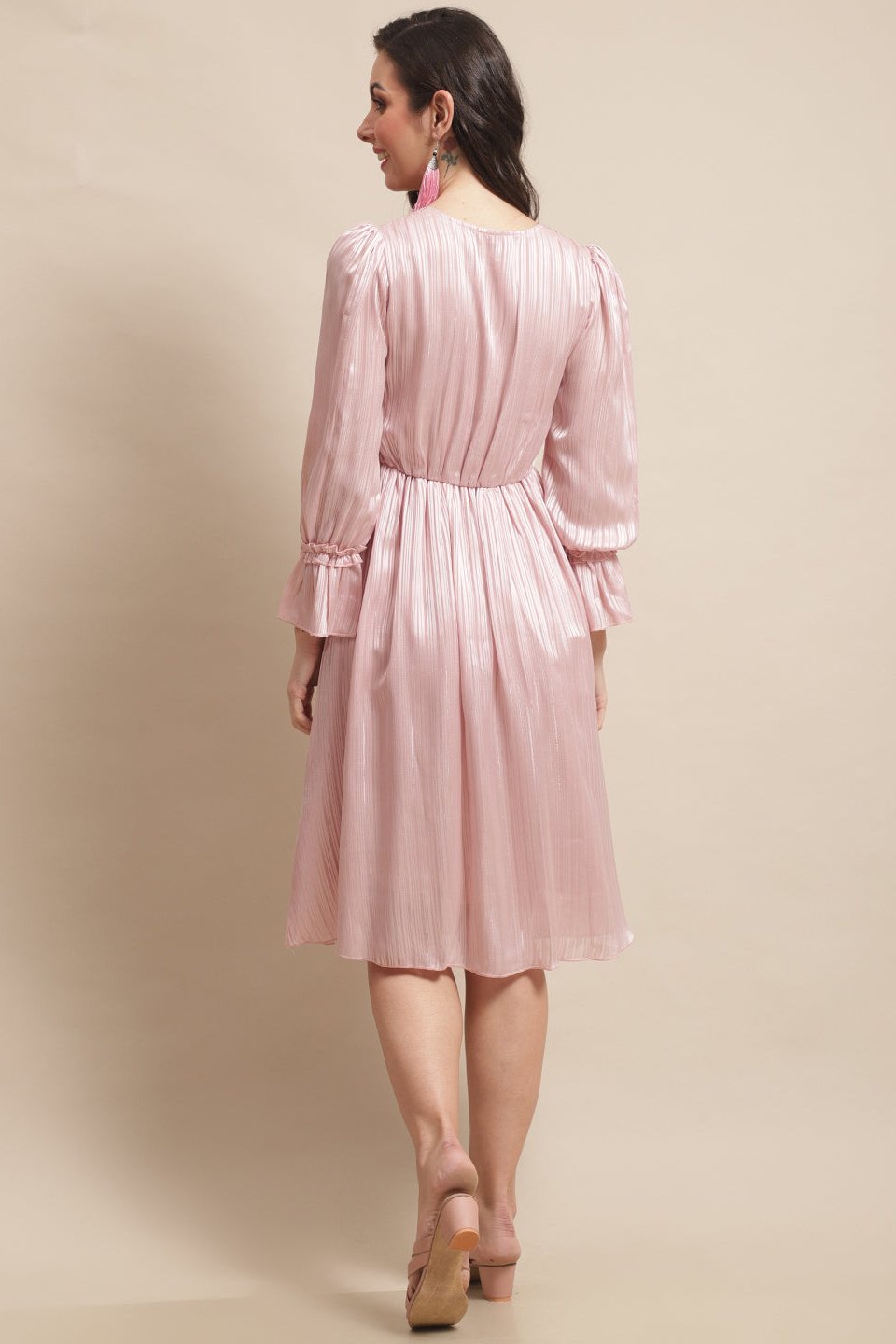 Back view of model in pink printed georgette dress