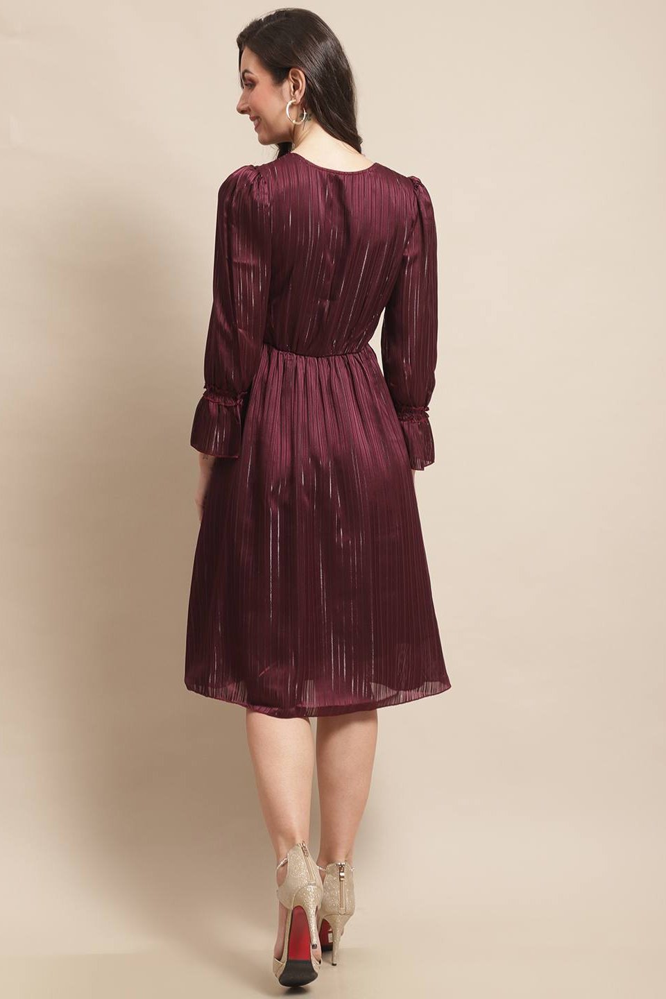 Back view of model in wine printed dress