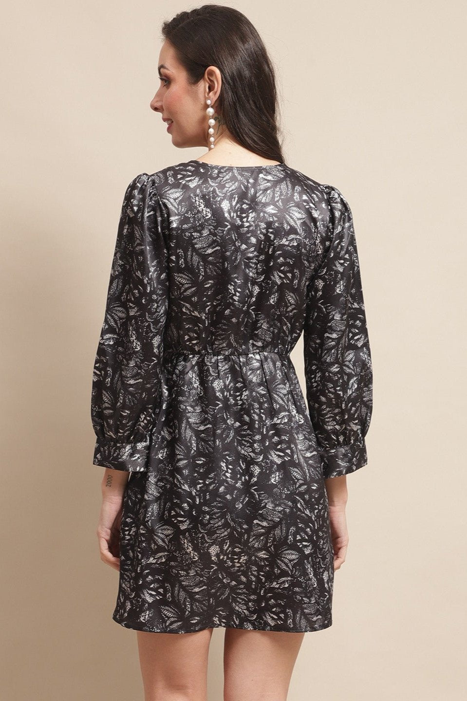 Back view of model in black satin dress