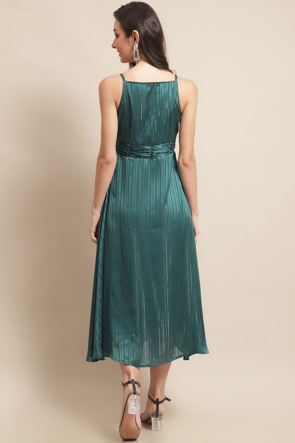 Back view of model in green georgette printed dress